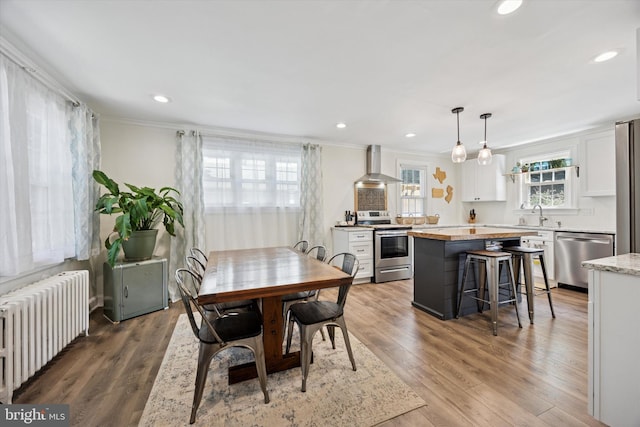 927 Drexel Ave, Drexel Hill, PA 19026 - dining area featuring radiator heating unit, crown molding, wood finished floors, and recessed lighting