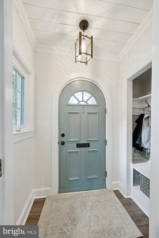 927 Drexel Ave, Drexel Hill, PA 19026 - entrance foyer featuring arched walkways, ornamental molding, and dark wood-type flooring