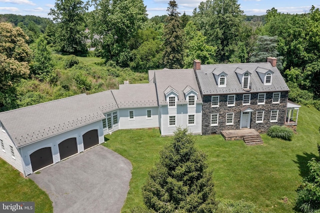 453 Bayard Rd, Kennett Square, PA 19348 - view of front of house with a chimney, a front yard, driveway, stone siding, and a wooded view