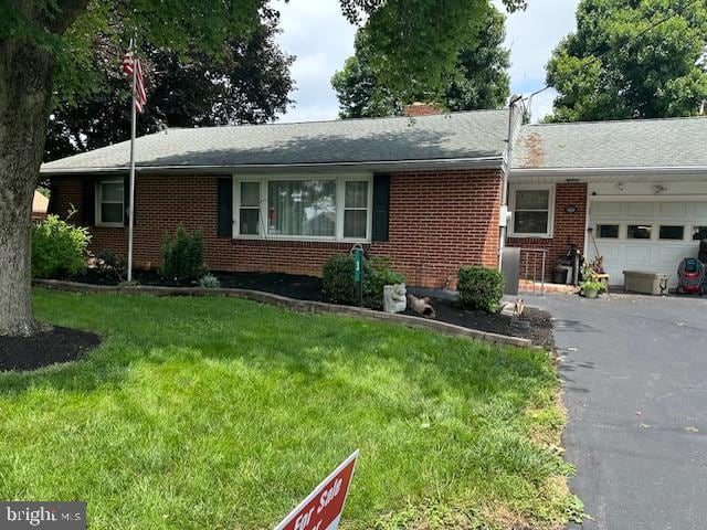 3 Pfautz Ave, Lititz, PA 17543 - ranch-style home with a garage, brick siding, asphalt driveway, a front yard, and a shingled roof
