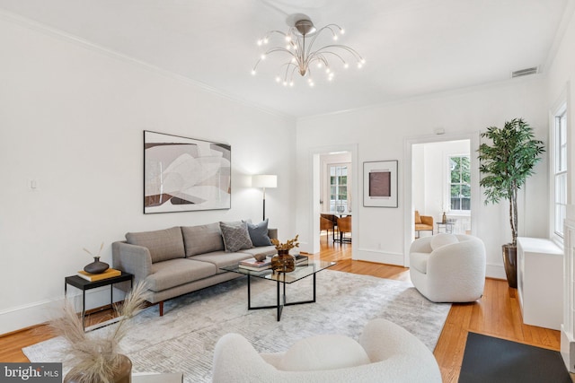 3518 35th St NW, Washington, DC 20016 - living area with light wood finished floors, a chandelier, and ornamental molding