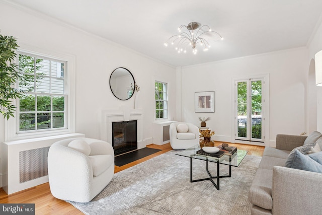 3518 35th St NW, Washington, DC 20016 - living room with healthy amount of natural light, a fireplace with flush hearth, wood finished floors, and ornamental molding
