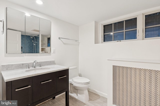 3518 35th St NW, Washington, DC 20016 - bathroom with vanity, a tile shower, wood finished floors, and recessed lighting
