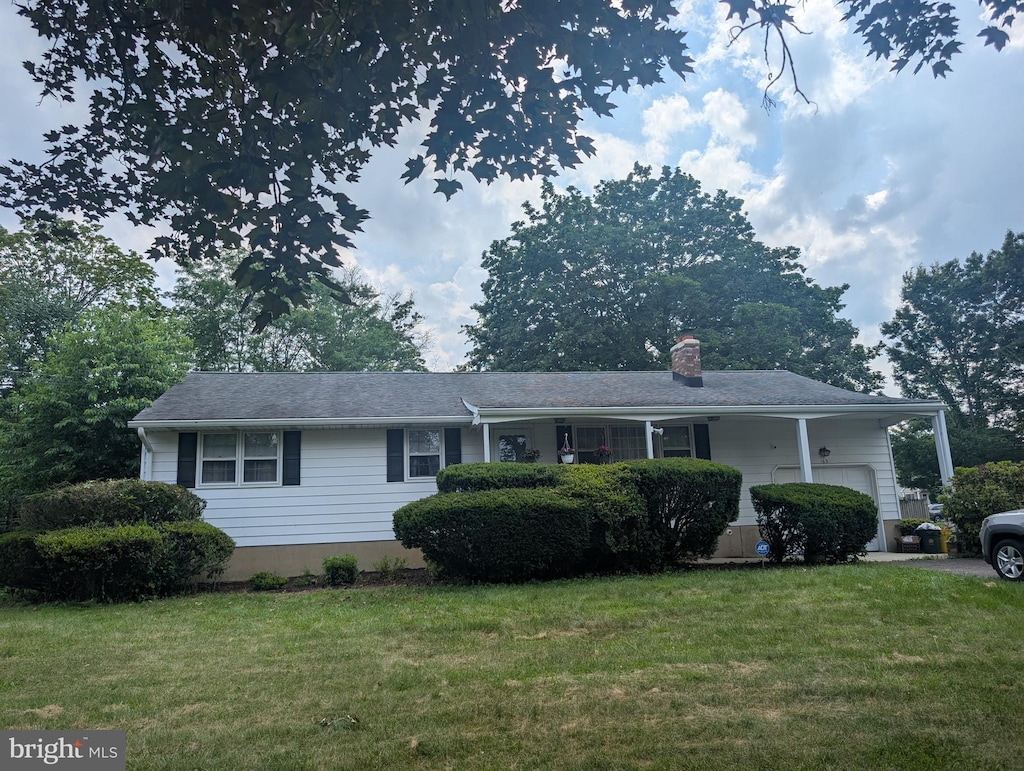 163 Hickory Corner Rd, Hightstown, NJ 08520 - ranch-style home with an attached garage, a front yard, and a chimney