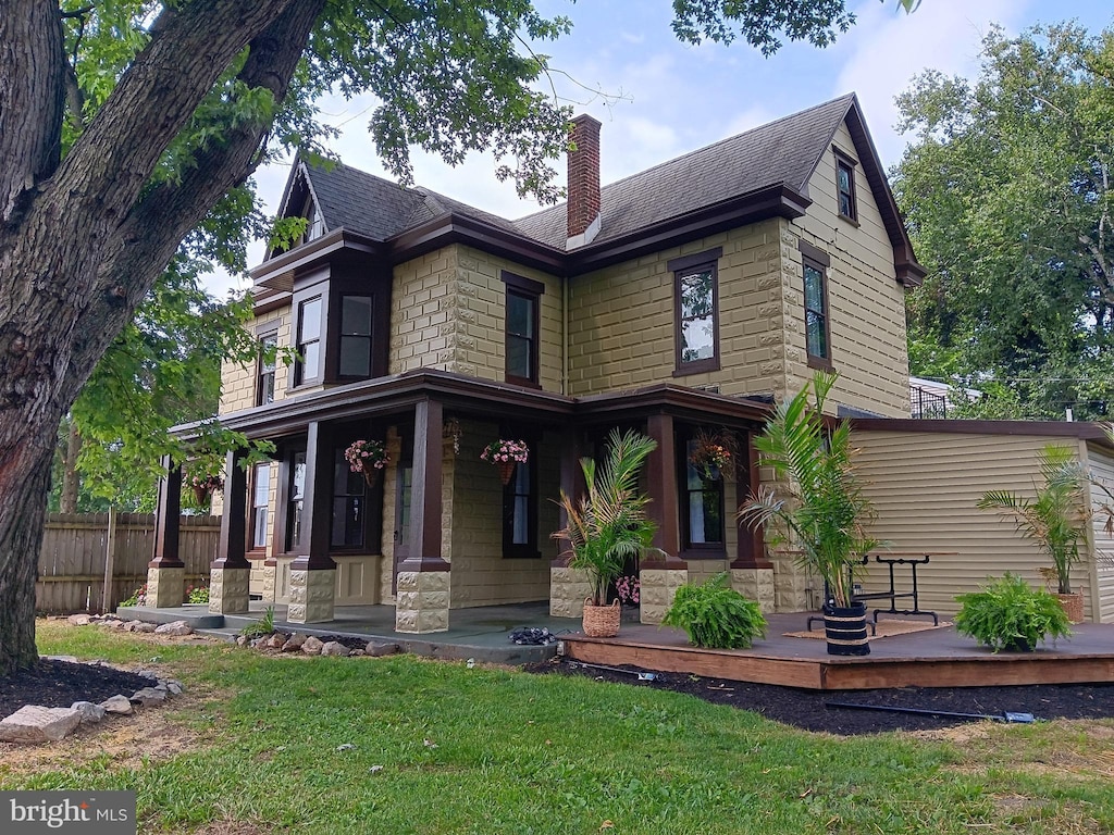 421 C St, Carlisle, PA 17013 - view of front of home featuring a porch, a chimney, roof with shingles, and stone siding