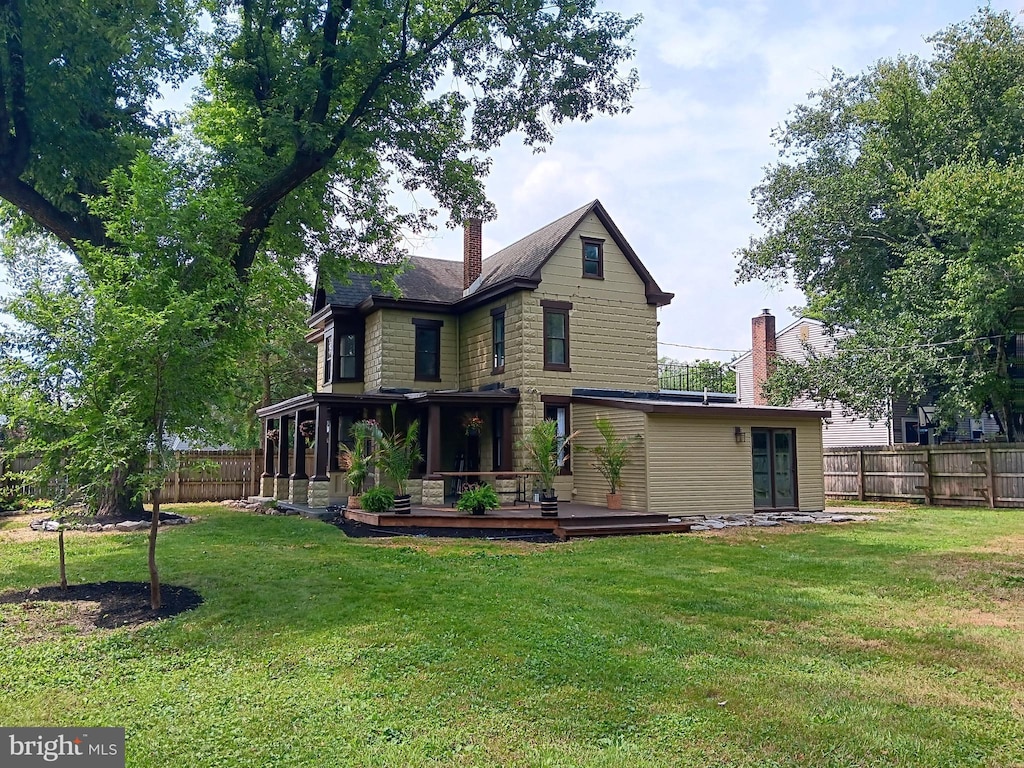 421 C St, Carlisle, PA 17013 - rear view of property with a deck, a fenced backyard, a chimney, and a sunroom