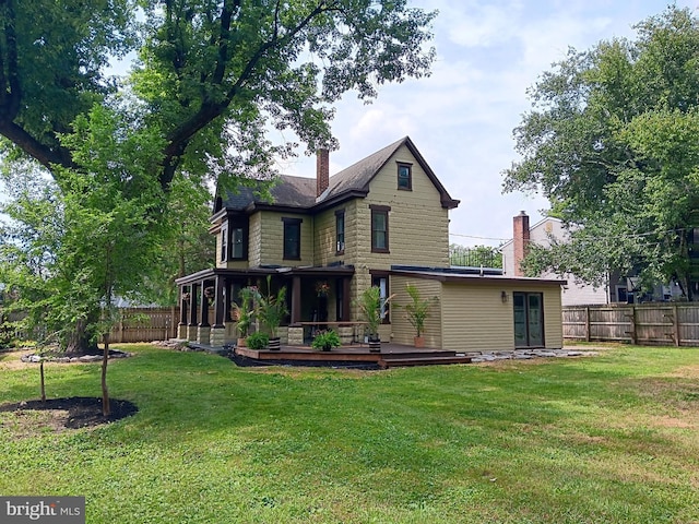 421 C St, Carlisle, PA 17013 - rear view of property with a deck, a fenced backyard, a chimney, and a sunroom