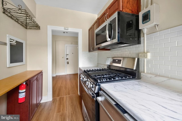 1954 Columbia Rd NW Unit 112, Washington, DC 20009 - kitchen featuring stainless steel appliances, light wood finished floors, and tasteful backsplash