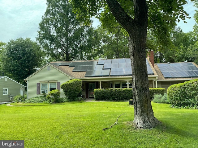 8717 Oxwell Ln, Laurel, MD 20708 - view of front facade featuring a front yard, solar panels, and a chimney