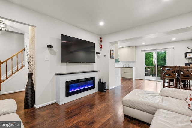 9304 Taverney Ter, Gaithersburg, MD 20879 - living room featuring wood finished floors, recessed lighting, stairs, and a glass covered fireplace