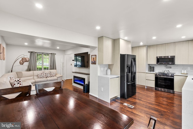 9304 Taverney Ter, Gaithersburg, MD 20879 - living area with dark wood finished floors, recessed lighting, and a glass covered fireplace