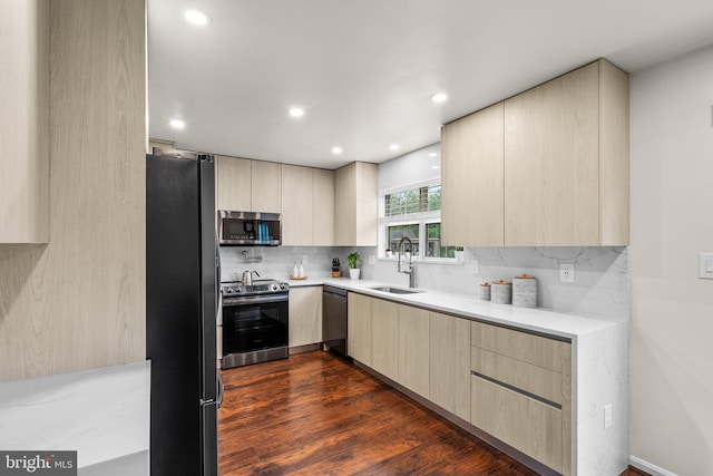 9304 Taverney Ter, Gaithersburg, MD 20879 - kitchen with appliances with stainless steel finishes, light brown cabinetry, modern cabinets, backsplash, and light countertops
