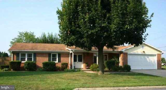 50 Eisenhower Dr, Chambersburg, PA 17201 - ranch-style home with brick siding, a garage, a front lawn, and concrete driveway