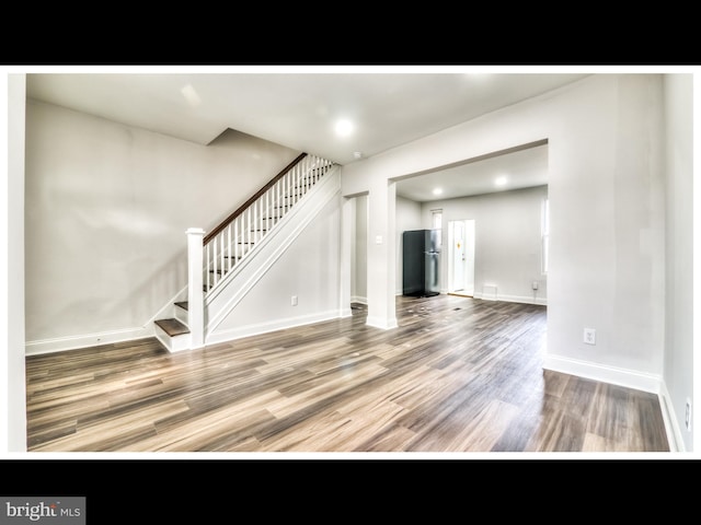 1206 Darley Ave, Baltimore, MD 21218 - unfurnished living room with stairs, wood finished floors, and recessed lighting