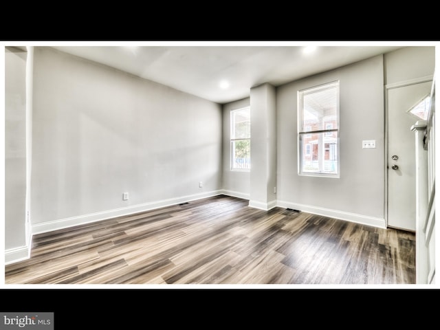 1206 Darley Ave, Baltimore, MD 21218 - empty room with wood finished floors and baseboards