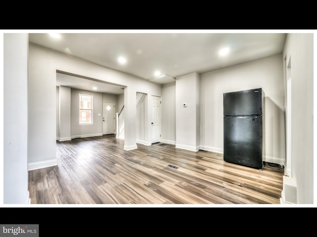 1206 Darley Ave, Baltimore, MD 21218 - unfurnished living room featuring wood finished floors, stairs, and recessed lighting