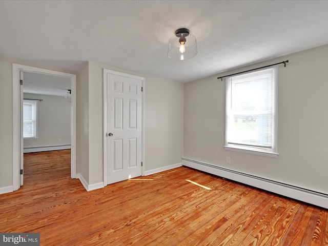 41 W George St, York, PA 17408 - unfurnished bedroom featuring a baseboard radiator and light wood-style flooring