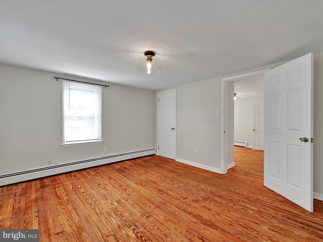 41 W George St, York, PA 17408 - unfurnished bedroom with baseboard heating and light wood-type flooring