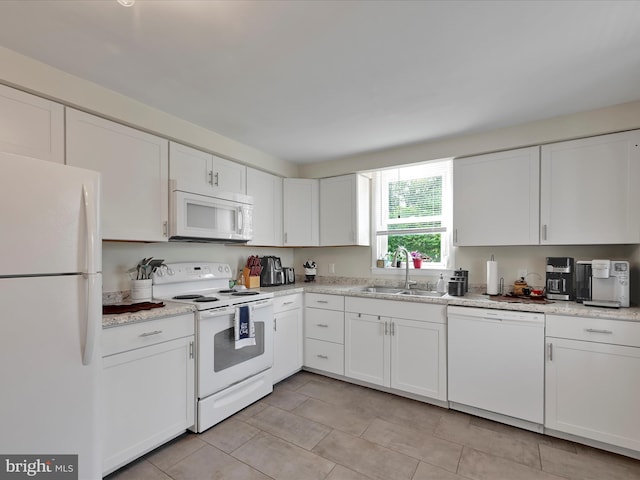 41 W George St, York, PA 17408 - kitchen with white appliances, white cabinetry, light tile patterned floors, and light stone counters