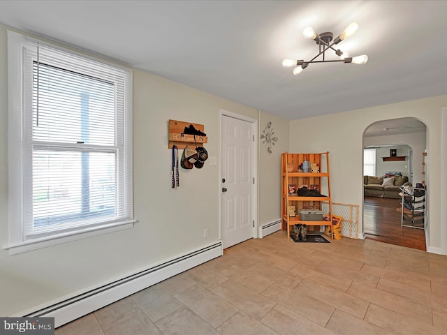 41 W George St, York, PA 17408 - foyer entrance with a baseboard heating unit, arched walkways, and a chandelier
