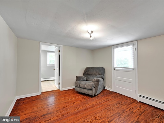 41 W George St, York, PA 17408 - living area featuring baseboard heating, a baseboard radiator, and wood finished floors