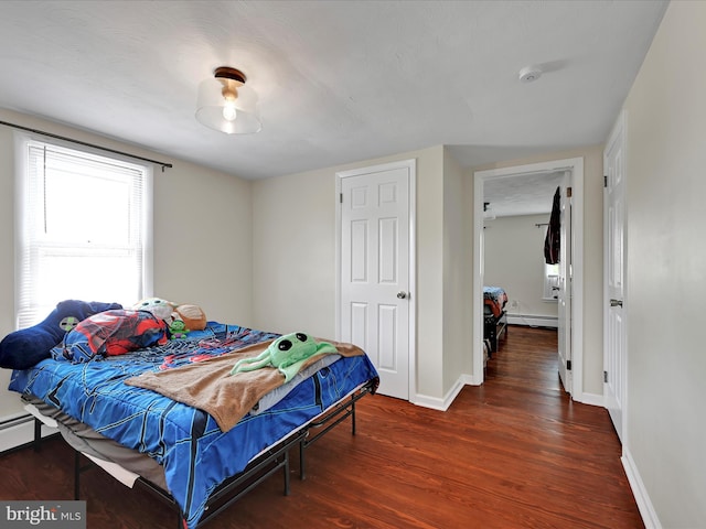 41 W George St, York, PA 17408 - bedroom with wood finished floors and a baseboard heating unit
