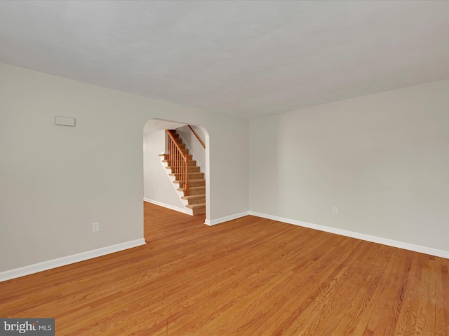 41 W George St, York, PA 17408 - unfurnished room with wood finished floors, stairway, and arched walkways