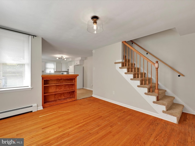 41 W George St, York, PA 17408 - unfurnished living room with stairs, light wood-style floors, and baseboard heating