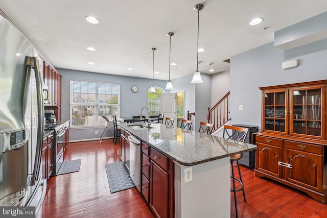 1108 Curtis Way, Glen Burnie, MD 21061 - kitchen with stainless steel appliances, a breakfast bar, dark wood-style floors, an island with sink, and glass insert cabinets