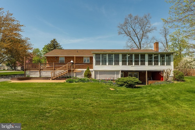38 Skyview Ln, Lititz, PA 17543 - back of property with a sunroom, a deck, a chimney, brick siding, and a yard