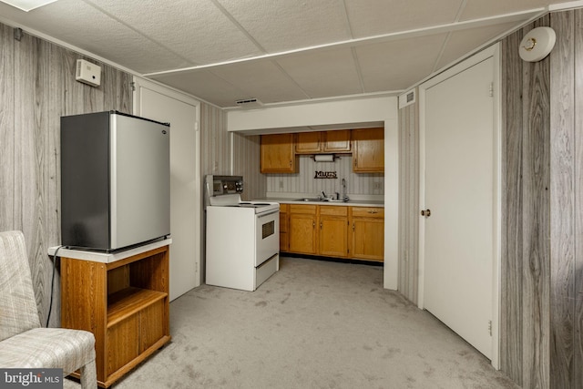 38 Skyview Ln, Lititz, PA 17543 - kitchen featuring white electric range, light carpet, freestanding refrigerator, light countertops, and brown cabinetry
