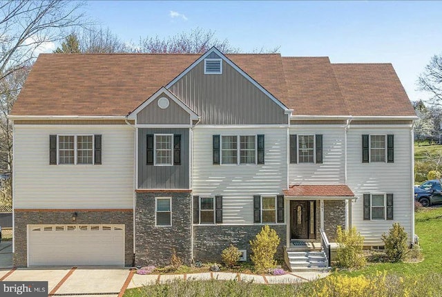 101 Malley St, Newtown Square, PA 19073 - view of front of house with an attached garage, stone siding, and driveway