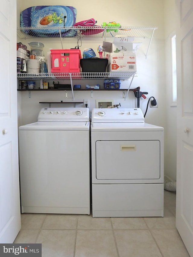 19988 Sandy Bottom Cir Unit 903, Rehoboth Beach, DE 19971 - laundry area featuring washer and dryer and light tile patterned floors