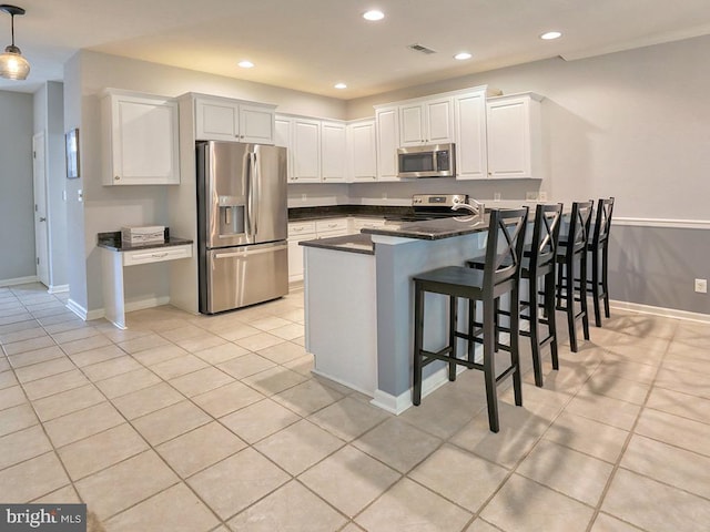 19988 Sandy Bottom Cir Unit 903, Rehoboth Beach, DE 19971 - kitchen with stainless steel appliances, a peninsula, dark countertops, white cabinets, and recessed lighting