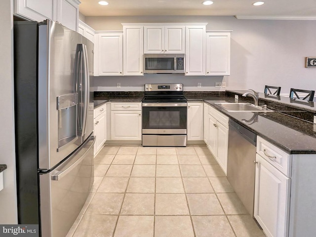 19988 Sandy Bottom Cir Unit 903, Rehoboth Beach, DE 19971 - kitchen featuring appliances with stainless steel finishes, recessed lighting, white cabinetry, a peninsula, and light tile patterned flooring