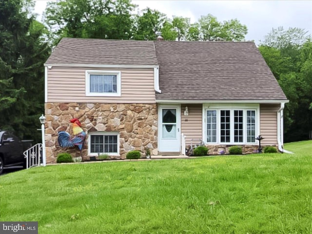 15 Pearson Dr, Springfield, PA 19064 - view of front of house with stone siding, a front yard, and a shingled roof