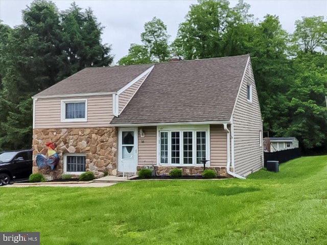 15 Pearson Dr, Springfield, PA 19064 - view of front of home with stone siding, a front lawn, and a shingled roof