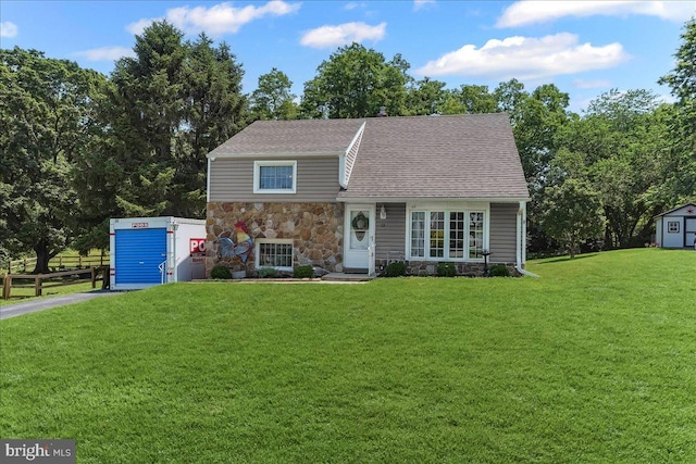 15 Pearson Dr, Springfield, PA 19064 - split level home featuring stone siding, a storage unit, and roof with shingles