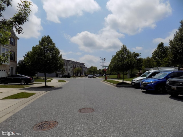 9545 Elizabeth Howe Ln, Owings Mills, MD 21117 - view of asphalt road featuring sidewalks, curbs, a residential view, and street lights