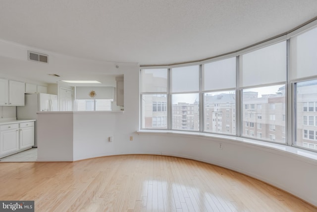 3835 9th St N Unit 1001W, Arlington, VA 22203 - unfurnished living room with light wood-style floors