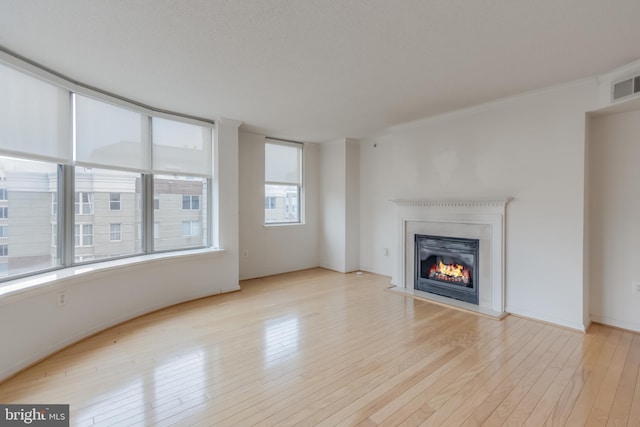 3835 9th St N Unit 1001W, Arlington, VA 22203 - unfurnished living room with wood finished floors and a glass covered fireplace