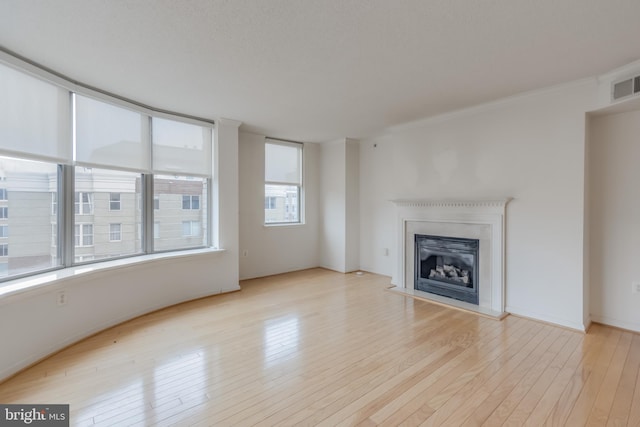 3835 9th St N Unit 1001W, Arlington, VA 22203 - unfurnished living room featuring wood finished floors and a fireplace with raised hearth