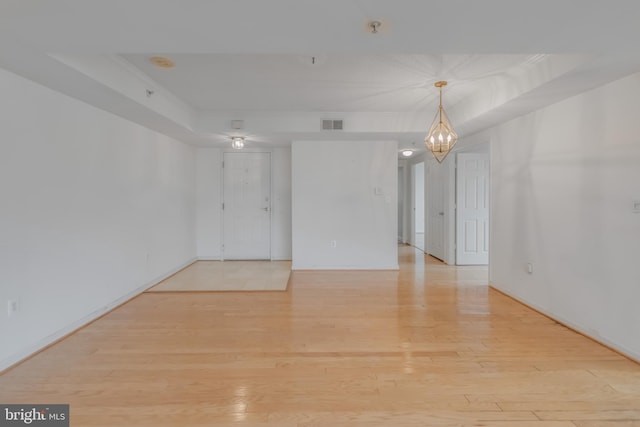 3835 9th St N Unit 1001W, Arlington, VA 22203 - unfurnished room featuring light wood-style floors, crown molding, a chandelier, a pendent fire sprinkler, and a smoke detector
