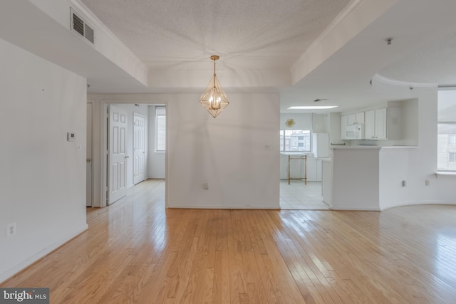 3835 9th St N Unit 1001W, Arlington, VA 22203 - unfurnished living room with light wood finished floors, a chandelier, and plenty of natural light