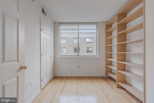 3835 9th St N Unit 1001W, Arlington, VA 22203 - unfurnished bedroom with light wood-style flooring and baseboards