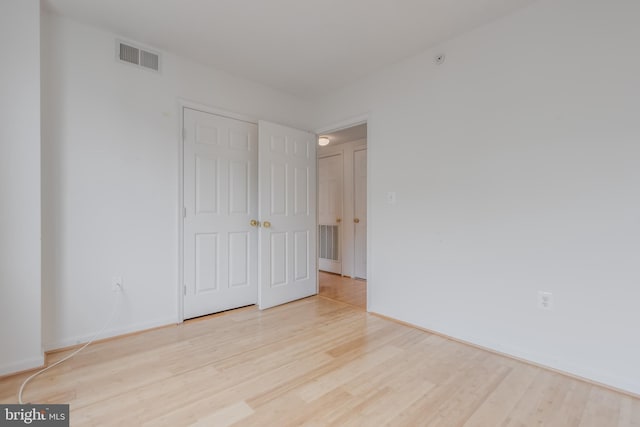 3835 9th St N Unit 1001W, Arlington, VA 22203 - unfurnished bedroom with light wood-style flooring and baseboards