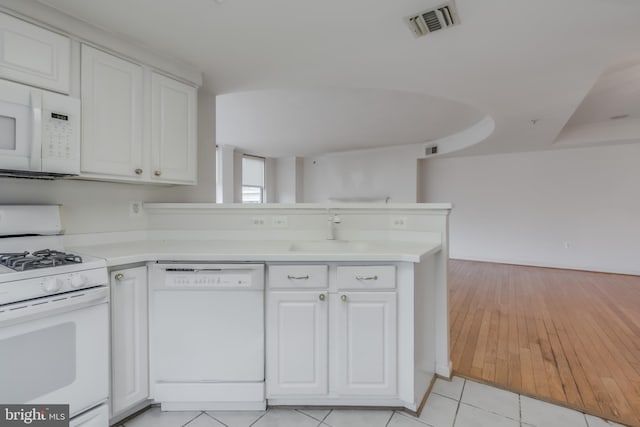 3835 9th St N Unit 1001W, Arlington, VA 22203 - kitchen featuring white appliances, a peninsula, white cabinetry, and light countertops