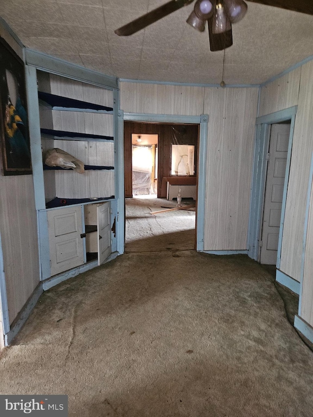 194 Blackwood Ave, Franklinville, NJ 08322 - unfurnished living room with carpet flooring, wood walls, and ceiling fan
