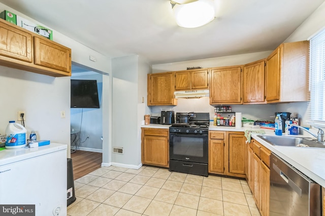 5349 Call Pl SE, Washington, DC 20019 - kitchen with black range with gas stovetop, stainless steel dishwasher, under cabinet range hood, and light countertops
