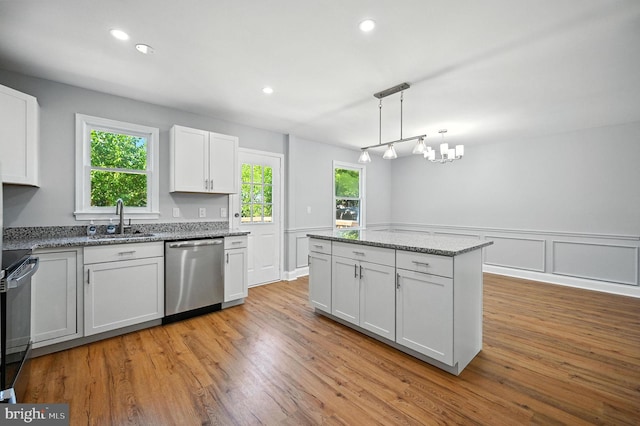 8591 King Carter St, Manassas, VA 20110 - kitchen with stainless steel appliances, light stone countertops, healthy amount of natural light, light wood-style flooring, and recessed lighting